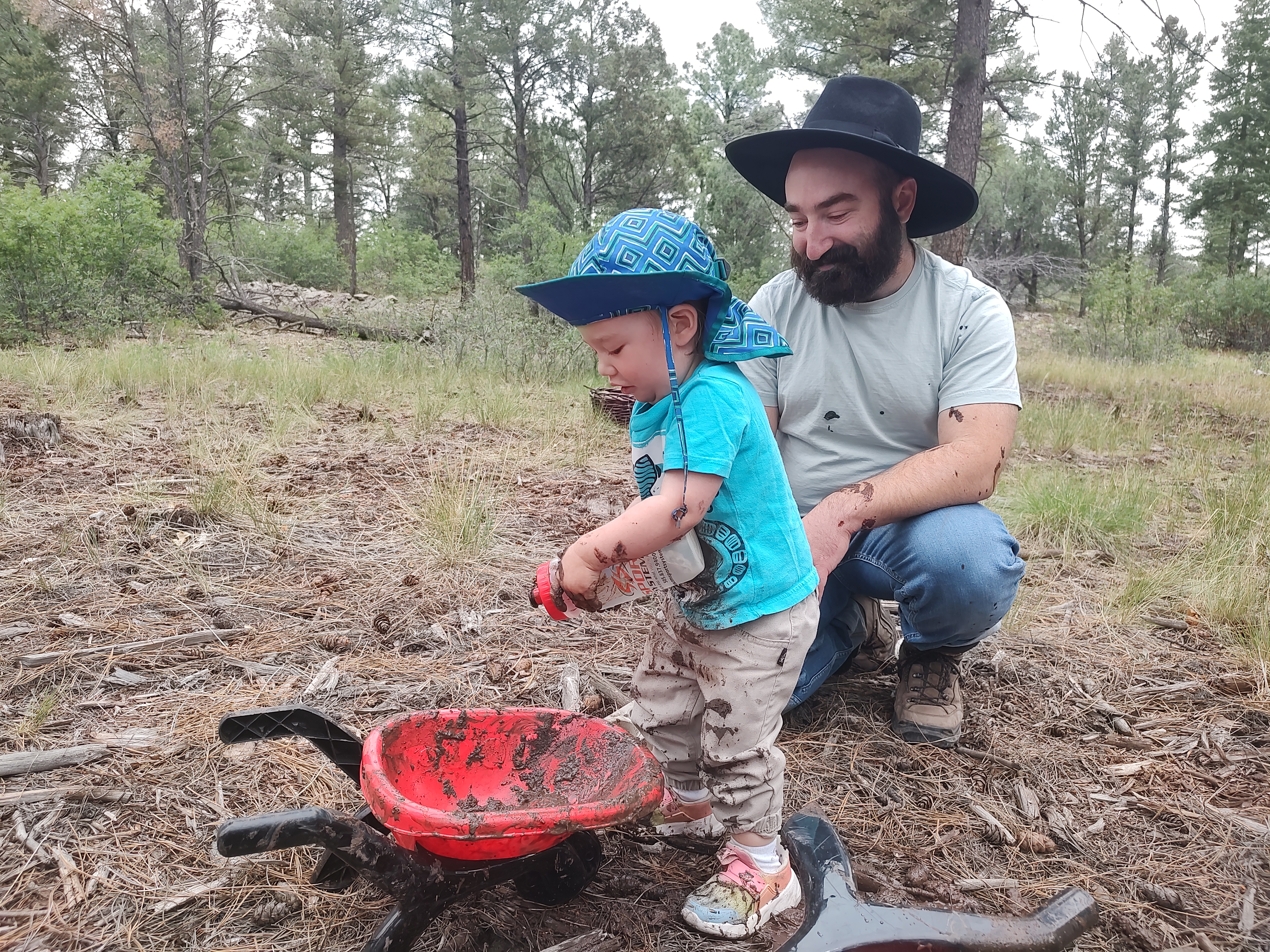 dad and child with play wheelbarrow